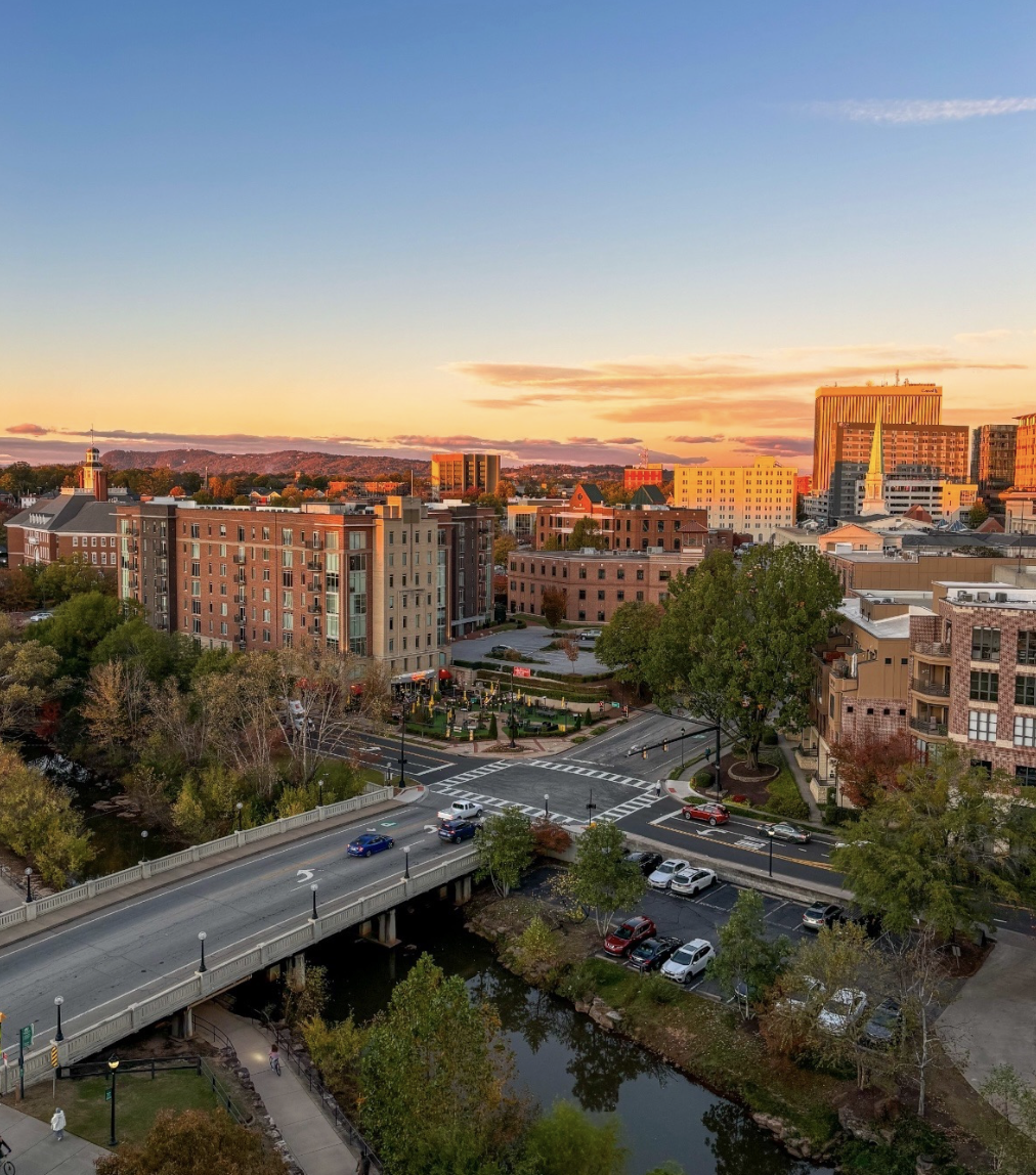 City skyline and bridge glowing at sunset