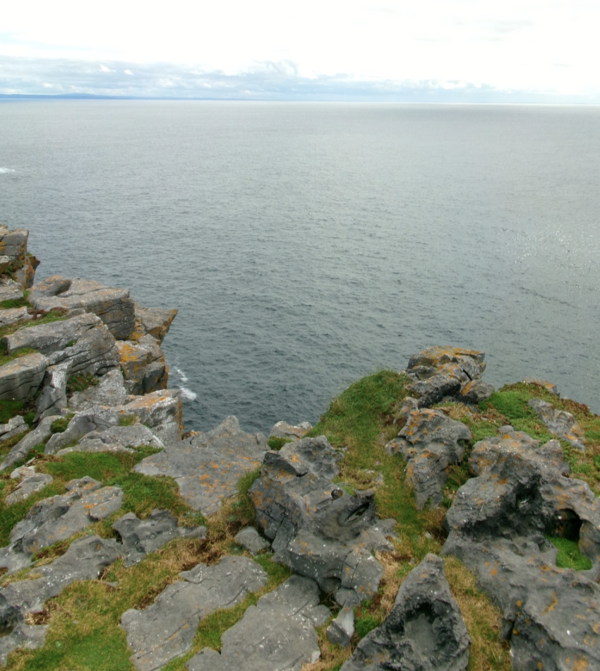 Rocky headland with lichen-covered stone and open sea