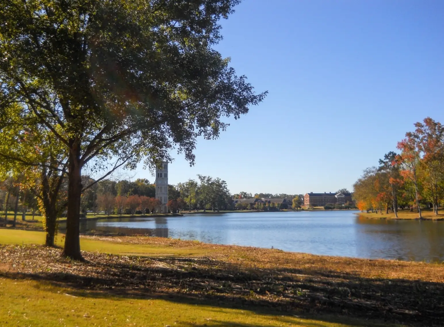 Bell tower across a lake on a bright autumn day