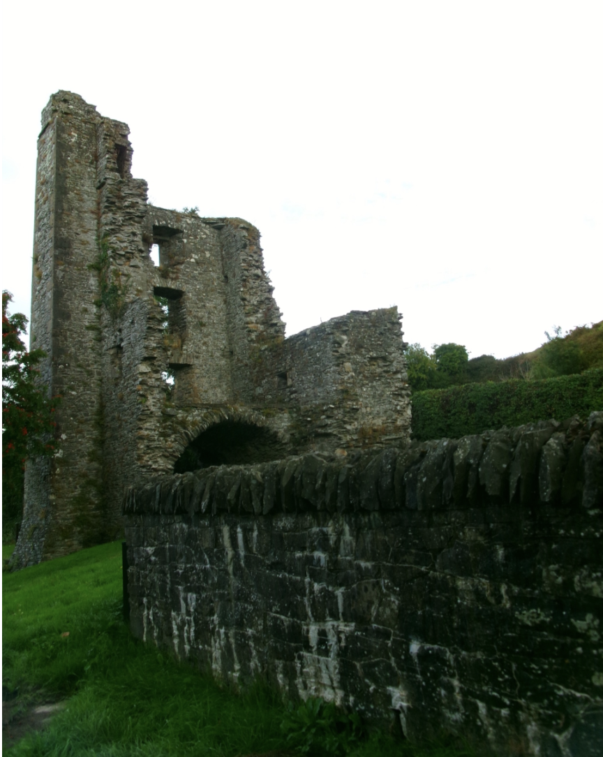 Stone wall leading to a medieval castle ruin